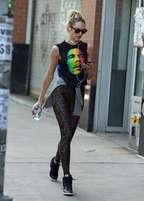 EXCLUSIVE: Victoria Secret model Candice Swanepoel walks around Soho with a Bob Marley t-shirt and leopard tights in New York City.